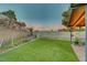 Backyard featuring artificial turf, brick walls, and vibrant plants at 4556 Kenilworth Ct, Las Vegas, NV 89147