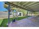 Charming backyard with covered patio, artificial grass, and storage shed at 4556 Kenilworth Ct, Las Vegas, NV 89147