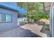 Backyard featuring a covered patio area, paved surfaces, trees, and an outdoor barbecue at 4556 Kenilworth Ct, Las Vegas, NV 89147