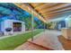 Backyard patio featuring synthetic grass, brick pavers, string lights, and a storage shed providing outdoor functionality at 4556 Kenilworth Ct, Las Vegas, NV 89147