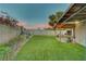 Fenced-in backyard with an artificial lawn and covered patio area at 4556 Kenilworth Ct, Las Vegas, NV 89147