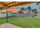 Backyard featuring artificial grass and a covered patio with lights at 4556 Kenilworth Ct, Las Vegas, NV 89147