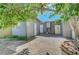 View of the paved backyard featuring mature trees, landscaping, shed, and a well-manicured lawn at 4556 Kenilworth Ct, Las Vegas, NV 89147