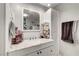 Bathroom features a vanity with marble countertop, white cabinets, and modern fixtures at 4556 Kenilworth Ct, Las Vegas, NV 89147