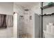 This is a tiled walk-in shower featuring a rainfall shower head and built in shelving at 4556 Kenilworth Ct, Las Vegas, NV 89147