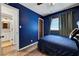 A blue bedroom offers a calming atmosphere with a window view and wood-look flooring at 4556 Kenilworth Ct, Las Vegas, NV 89147