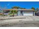 Charming single-story home featuring a two-car garage, xeriscaping, and mature palm tree at 4556 Kenilworth Ct, Las Vegas, NV 89147