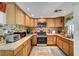 Updated kitchen with wood cabinets, stainless steel appliances, and tile backsplash at 4556 Kenilworth Ct, Las Vegas, NV 89147