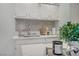 Stylish kitchen showcases white quartz countertops, a mosaic backsplash, and modern stainless steel sink at 5171 Lindell Rd # 201, Las Vegas, NV 89118