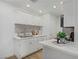 Bright kitchen features white cabinetry, stainless steel sink and appliances, plus modern, recessed lighting at 5171 Lindell Rd # 201, Las Vegas, NV 89118