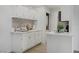Bright, renovated kitchen features white cabinets, stainless steel sink and appliances, and a stylish backsplash at 5171 Lindell Rd # 201, Las Vegas, NV 89118