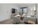 Inviting living room is virtually staged with modern furnishings and a sliding glass door to a balcony at 5171 Lindell Rd # 201, Las Vegas, NV 89118