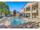 Community pool with a spa, surrounded by lounge chairs and well-maintained landscaping at 5171 Lindell Rd # 201, Las Vegas, NV 89118