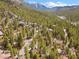 Aerial view of home nestled in the forest with mountain views at 5230 Whispering Robin Ln, Mount Charleston, NV 89124