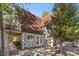 Backyard area with patio chairs, wood accents, and treeline at 5230 Whispering Robin Ln, Mount Charleston, NV 89124