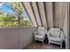 Balcony featuring two armchairs that overlooks towering pine trees and offers outdoor living space at 5230 Whispering Robin Ln, Mount Charleston, NV 89124