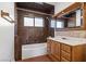 Cozy bathroom featuring a shower-tub combo and vanity with wood cabinetry and marble countertops at 5230 Whispering Robin Ln, Mount Charleston, NV 89124