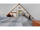 A-frame bedroom with a ceiling fan, sliding mirror closet doors, and unique wood burning stove at 5230 Whispering Robin Ln, Mount Charleston, NV 89124