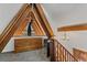 Attic bedroom with exposed beam detail, an antique dresser, and stylish chandelier at 5230 Whispering Robin Ln, Mount Charleston, NV 89124