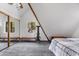 Cozy bedroom with exposed wooden beams, a ceiling fan, sliding mirror closet doors, and carpeted floors at 5230 Whispering Robin Ln, Mount Charleston, NV 89124