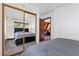 Bedroom featuring neutral walls, carpeted floors, sliding mirror closet doors, and natural light at 5230 Whispering Robin Ln, Mount Charleston, NV 89124