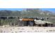 Stunning exterior view of a modern building nestled against a scenic mountain backdrop at 5230 Whispering Robin Ln, Mount Charleston, NV 89124
