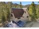 Gray A-frame home with newer roof and solar panels at 5230 Whispering Robin Ln, Mount Charleston, NV 89124