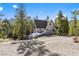 Charming gray A-frame home with solar panels surrounded by lush trees at 5230 Whispering Robin Ln, Mount Charleston, NV 89124