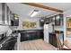 Bright kitchen with black cabinets, marble countertops, and an adjacent breakfast nook at 5230 Whispering Robin Ln, Mount Charleston, NV 89124