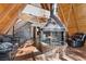 A-frame living room with a statement brick fireplace and wood beams at 5230 Whispering Robin Ln, Mount Charleston, NV 89124
