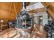 A-frame living room with a unique brick fireplace, wood paneling, and views of the surrounding forest at 5230 Whispering Robin Ln, Mount Charleston, NV 89124