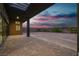 An outdoor patio with a brick floor, covered roof, and views of the sunset sky at 5364 Succulent Rose Dr, Las Vegas, NV 89135