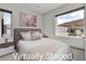 This virtually staged bedroom features lots of light, mountain views, and neutral decor at 5364 Succulent Rose Dr, Las Vegas, NV 89135