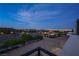 Balcony view showcasing the neighborhood, landscaping, and distant city lights against a twilight sky at 5364 Succulent Rose Dr, Las Vegas, NV 89135