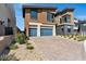 Attractive modern home with a three-car garage and manicured landscaping, enhancing its curb appeal and functionality at 5364 Succulent Rose Dr, Las Vegas, NV 89135
