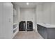 Well-equipped laundry room featuring a washer, dryer, sink, and ample storage space, designed for convenience at 5364 Succulent Rose Dr, Las Vegas, NV 89135