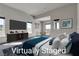 Tranquil main bedroom featuring an entertainment center, comfortable seating area, and ample natural light at 5364 Succulent Rose Dr, Las Vegas, NV 89135