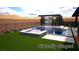 A modern pool and spa area with a waterfall feature, surrounded by lush landscaping and a desert backdrop at 5364 Succulent Rose Dr, Las Vegas, NV 89135