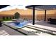 This backyard features a stunning pool and spa with a modern waterfall feature, perfect for outdoor relaxation at 5364 Succulent Rose Dr, Las Vegas, NV 89135