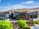 Stunning modern home with sleek architecture, large windows, and beautifully landscaped surroundings, offering privacy at 5364 Succulent Rose Dr, Las Vegas, NV 89135