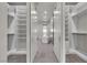 Spacious walk-in closet with custom shelving and a view of the luxurious soaking tub in the ensuite bathroom at 5364 Succulent Rose Dr, Las Vegas, NV 89135