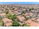 Expansive aerial view of a residential neighborhood, showcasing a sea of tile roofs and lush greenery at 5639 Guiding Star Cir, North Las Vegas, NV 89031