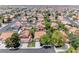 This aerial view showcases a neighborhood with uniform tile roofs, mature trees, and well-maintained landscaping at 5639 Guiding Star Cir, North Las Vegas, NV 89031