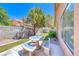 Landscaped backyard featuring a dining table with benches at 5639 Guiding Star Cir, North Las Vegas, NV 89031