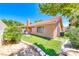 This backyard features lush grass, block wall fencing, and a low brick border accenting the landscaping at 5639 Guiding Star Cir, North Las Vegas, NV 89031