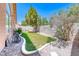 A charming backyard with a combination of gravel, greenery, and mature trees at 5639 Guiding Star Cir, North Las Vegas, NV 89031
