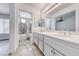 Bathroom featuring dual sinks, updated vanity, granite-look tile flooring, and shower-tub combination at 5639 Guiding Star Cir, North Las Vegas, NV 89031