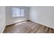 A bedroom featuring laminate flooring, window with blinds, and neutral paint at 5639 Guiding Star Cir, North Las Vegas, NV 89031