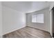An additional bedroom featuring laminate flooring, a window, and a sliding door closet at 5639 Guiding Star Cir, North Las Vegas, NV 89031
