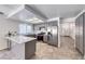 Modern kitchen with stainless steel appliances, grey cabinetry, tile floor, and breakfast bar at 5639 Guiding Star Cir, North Las Vegas, NV 89031